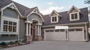 carriage style garage doors on large family home with gabled roof