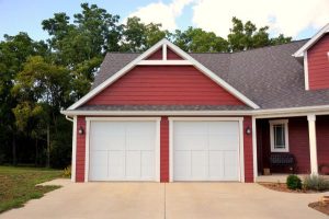 Red home with white garage doors